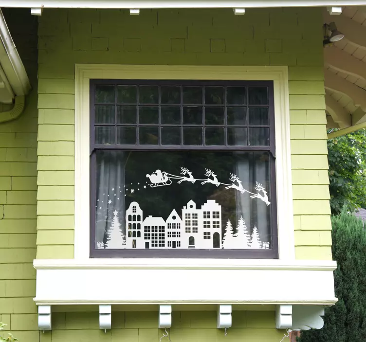 Renar som flyger över husen jul klistermärke - Tenstickers